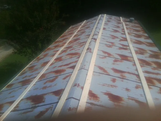 Rusted metal roof panels with new wood purlins before replacement — Storm Damage Roof Repair in Elkview by Roofing Brothers
